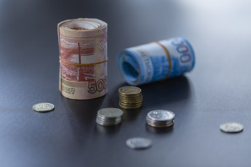 Russian banknotes and coins on a black background. Close up. 