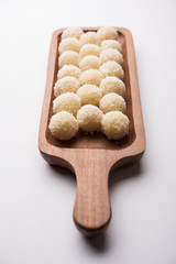 Coconut Sweet Laddoo OR Nariyal Ladduis a Popular Festival food from India. Served over moody background, selective focus