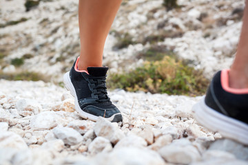 Legs of hiker woman on trekking trail in mountain, travel and active lifestyle concept