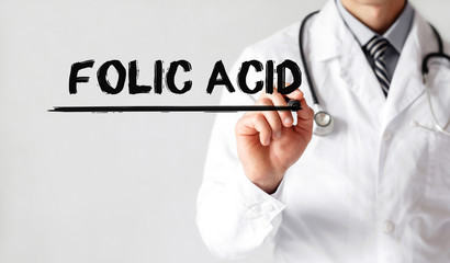 Doctor writing word Folic Acid with marker, Medical concept