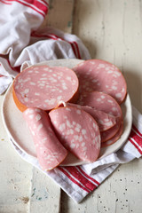 The cut  a sausage on a plate