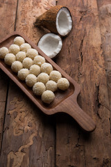 Coconut Sweet Laddoo OR Nariyal Ladduis a Popular Festival food from India. Served over moody background, selective focus