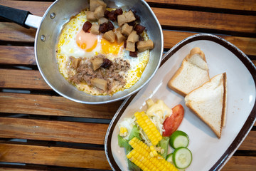 Close up breakfast food in Thai style ,Indochina pan-fried egg with pork and toppings ,salad .Selective focus ,vintage tone