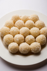 Coconut Sweet Laddoo OR Nariyal Ladduis a Popular Festival food from India. Served over moody background, selective focus