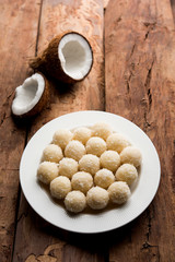 Coconut Sweet Laddoo OR Nariyal Ladduis a Popular Festival food from India. Served over moody background, selective focus