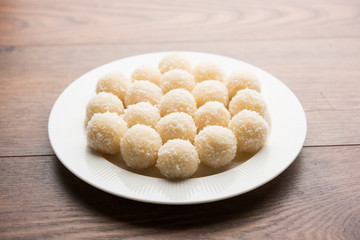 Coconut Sweet Laddoo OR Nariyal Ladduis a Popular Festival food from India. Served over moody background, selective focus