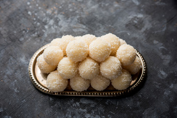 Coconut Sweet Laddoo OR Nariyal Ladduis a Popular Festival food from India. Served over moody background, selective focus