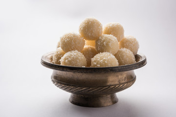 Coconut Sweet Laddoo OR Nariyal Ladduis a Popular Festival food from India. Served over moody background, selective focus