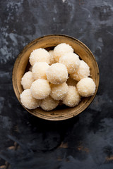 Coconut Sweet Laddoo OR Nariyal Ladduis a Popular Festival food from India. Served over moody background, selective focus