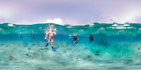 Tourists swimming in ocean