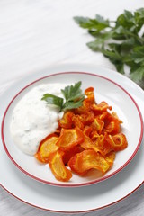 Carrot chips with sauce on a plate. Vertical.