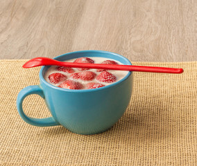 Berry strawberries with yoghurt  in a blue bow