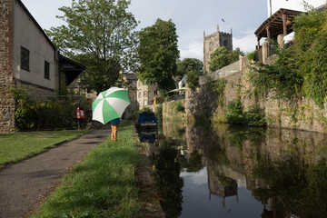 Child with umbrella standing next to the Leeds Liverpool canal
