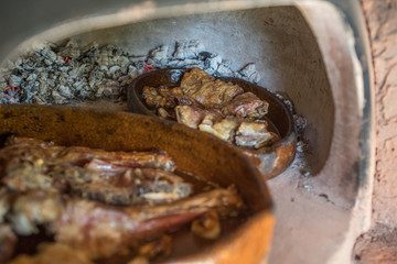 rich lamb or kid roasted in clay dish made in embers oven