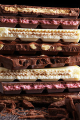 Chocolate bars on table with chocolate tower.