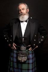 mature male model wearing kilt with grey hairstyle and beard - obrazy, fototapety, plakaty