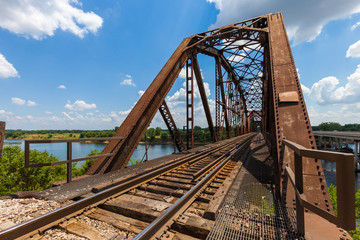 Old rusty truss railroad bridge over the Red River on the border of Texas and Oklahoma