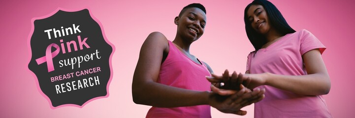 Composite image of two black women joining hands
