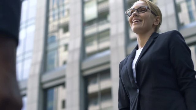 Business woman shaking hand with coworker, interpreter acquainting with client