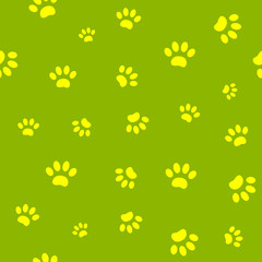 Seamless pattern of yellow paw prints on green background.