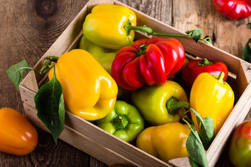 Colorful bell pepper in wooden crate