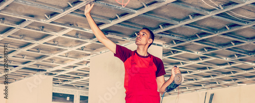 Construction Worker Assemble A Suspended Ceiling With