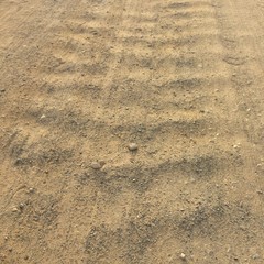 road from gravel as background, soil as texture, wavy country road