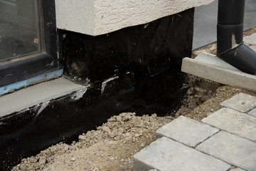 Waterproofing house foundation with spray on tar