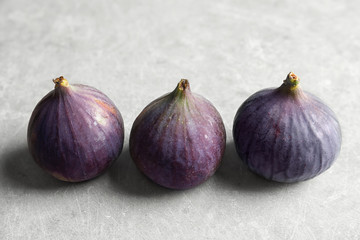 Fresh ripe figs on gray background. Tropical fruit