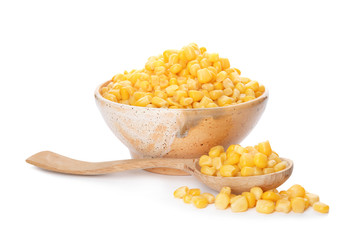 Bowl and spoon with corn kernels on white background