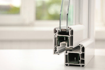 Sample of modern window profile on table, closeup. Space for text