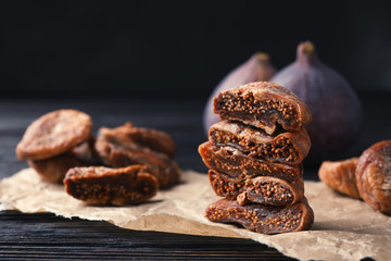 Delicious dried figs on parchment, closeup. Organic snack