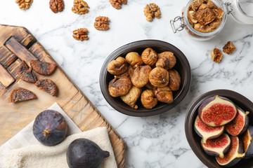 Flat lay composition with walnuts, fresh and dried figs on marble background