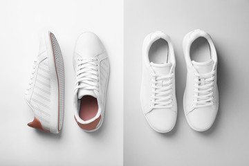 Pair of trendy sneakers on light background, flat lay