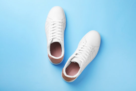 Pair of sneakers on color background, flat lay