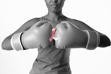 Woman for breast cancer awareness with ribbon in boxing gloves