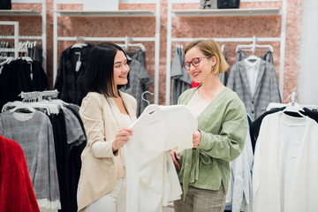 Obraz premium Fashion consultant showing clothes to the client