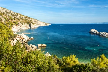 Island of Hvar. A place for a peaceful holiday. Coastal rocks in the Adriatic Sea. Blue sky.