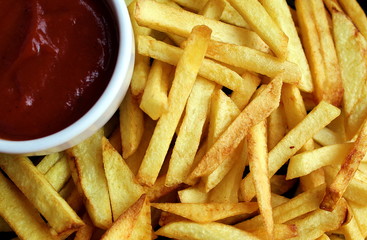 tasty harmful french fries with sauce background