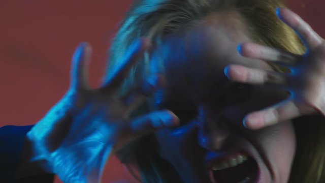 4k, slow motion, Halloween. Woman in costume of a terrible witch, swears looking at the camera, close-up