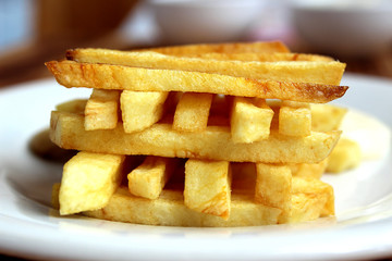 french fries on a cutting board with a cone