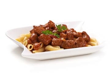 Pasta with goulash with parsley leaf, isolated on white background. Close-up.