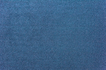 Texture of a dark blue carpet. Close-up of gradient light