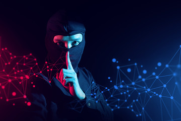 hacker guy in ninja costume with red and blue light in security hack to digital global network...