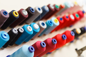 A set of coils with colorful threads in the sewing workshop.