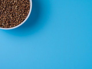 buckwheat in white cup on a blue background