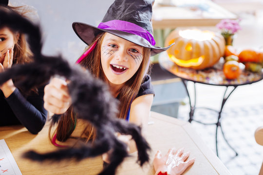 Purple lips. Beaming dark-haired girl with purple lips wearing wizard Halloween costume while attending party