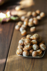 hazelnuts in a bowl on wooden table