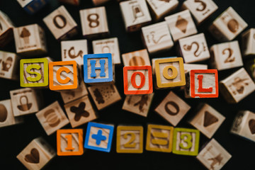 .Wooden squares with letters. Concept of learning Blocks for children. School word. Lifestyle.