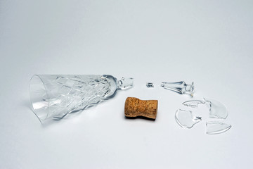 Broken crystal wineglass and cork plug